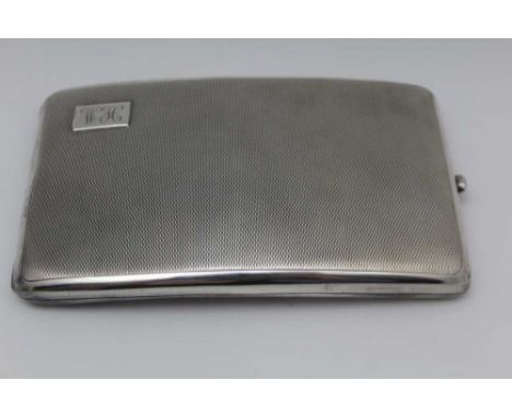 AN EARLY 20TH CENTURY SILVER CIGARETTE CASE, engine turned decoration, monogrammed 'WH', gilded interior, Birmingham 1918, 14