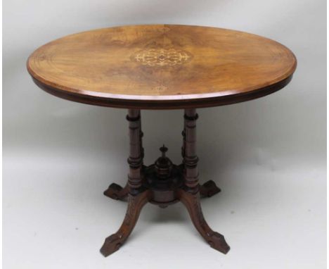 A VICTORIAN WALNUT INLAID OVAL TOPPED CENTRE STYLE TABLE on four ring turned legs united by a cylindrical boss, 72cm x 87cm 