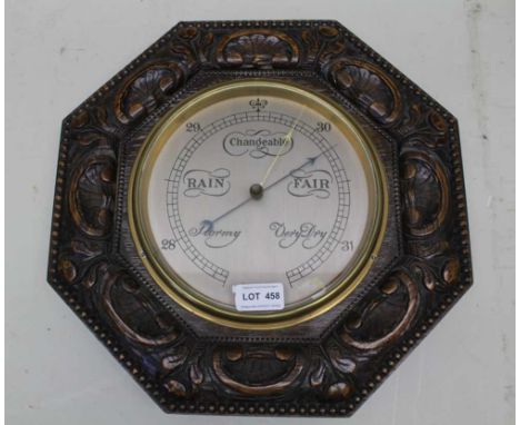 AN EDWARDIAN CARVED OCTAGONAL OAK FRAMED WALL BAROMETER, silvered dial, 36cm 