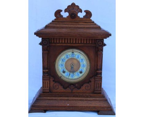 A LATE 19TH / EARLY 20TH CENTURY OAK CASED ARCHITECTURAL DESIGN MANTEL CLOCK, by Ansonia of New York, with pendulum, no key, 