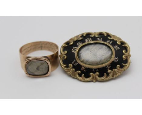 A 19TH CENTURY MOURNING BROOCH, black enamel framed, inscribed 'In Memory of', with hair plaited to the centre, 3.5cm x 2.5cm
