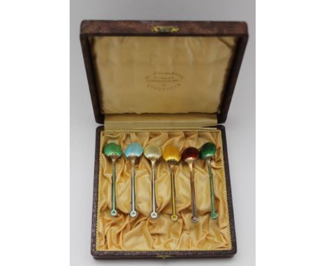 A CASED SET OF SIX SILVER GILT &amp; HARLEQUIN ENAMEL COFFEE SPOONS, considered to be Swedish, 62g, in a 'H. Johnson, Stockho