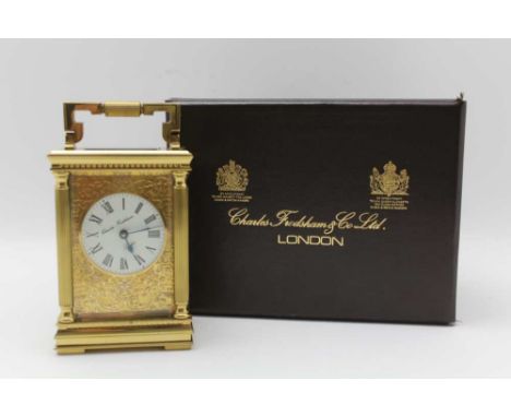 A CHARLES FRODSHAM CARIAGE CLOCK, ornate gilded brass case with columns at the case corners, dial with Roman numerals, 11.5cm