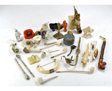 A group of varied and vintage smoking pipes, some with fine detail comprising ceramic, wooden and metal issues. All with age.