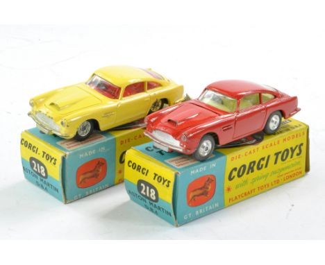 Corgi No. 218 Aston Martin DB4 Duo. One is red with lemon interior, spun wheels, the other is yellow with red interior, cast 