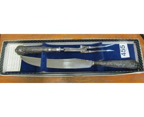 A silver handled carving knife and fork (boxed)