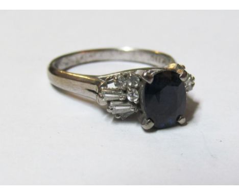 A gold coloured sapphire and diamond ring marked 18k