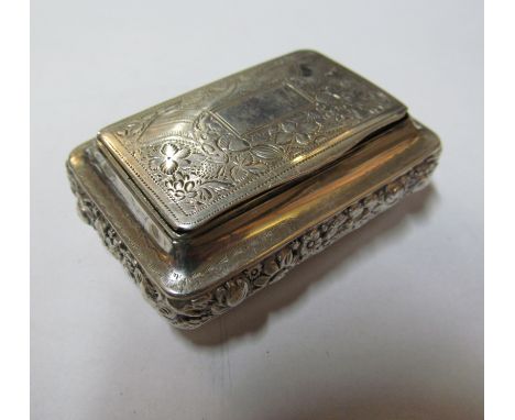 A silver snuff box with embossed border