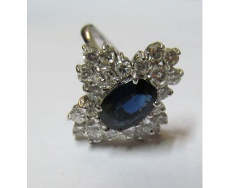 A gold coloured sapphire and diamond cluster ring marked 14k 1.78 on shank