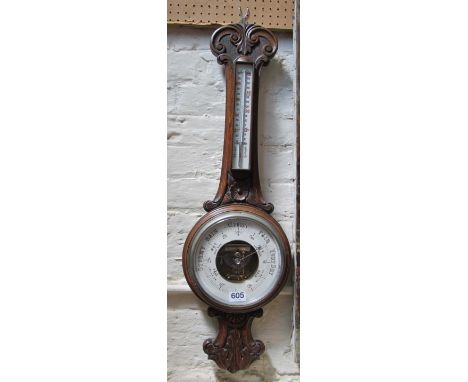 An oak cased barometer/thermometer