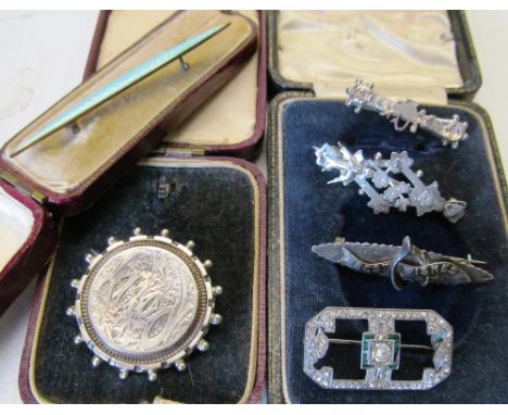 A silver best wishes brooch, three other silver brooches, and Art Deco 935 brooch (green stone missing) and blue enamel brooc