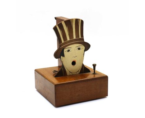 A French musical box cigarette dispenser, circa 1930s, modelled as a man with a top hat, on a mahogany plinth, with a wooden 