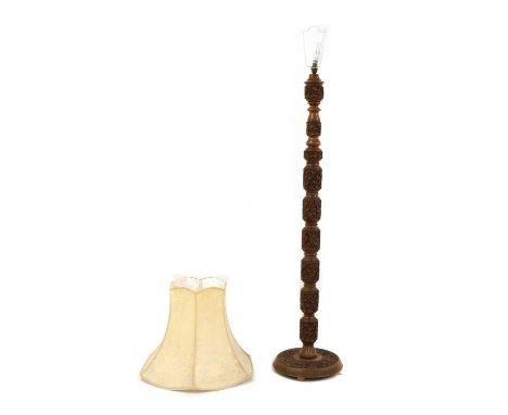 A Kashmir carved hardwood standard lamp, the turned sectional column and circular base profusely decorated with flowerhead de