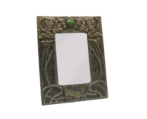 An Arts &amp; Crafts pewter table mirror, circa 1935, of rectangular form, with embossed decoration on the form of a fox unde