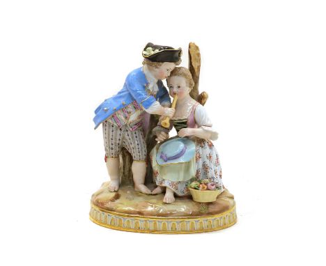 A Meissen porcelain figural group, depicting a young boy and girl playing the pipe, seated on a tree stump on circular natura