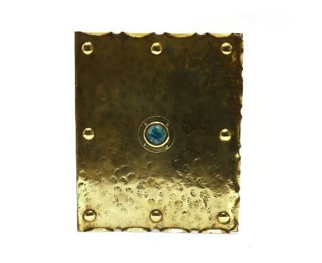 An Arts &amp; Crafts brass blotter, circa 1900, with a scalloped edge, with embossed roundels along the edges, with a central