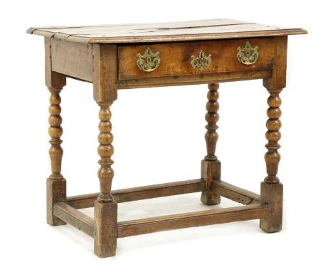 A walnut side table, with a moulded top, single drawer, with later brassware, on bobbin turned supports united with rail stre