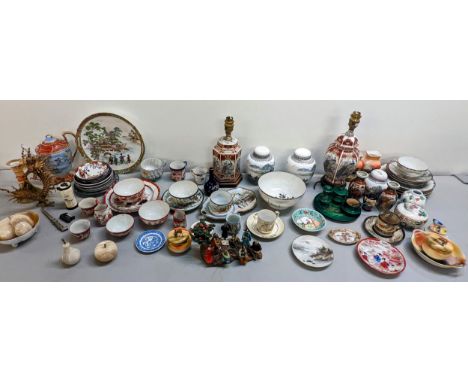 A mixed lot of Chinese and Japanese ceramics to include ginger jars, bowls, teacups and plates, vases converted to lamps, snu