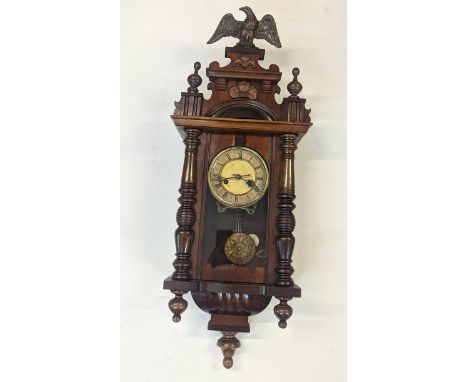 A mahogany cased Vienna style wall clock having Roman numerals and Eagle finial Location: 
