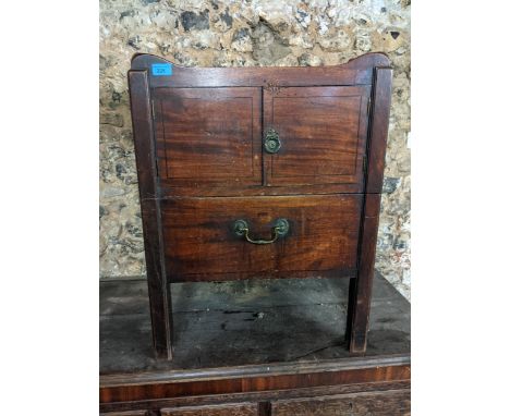 A Georgian III mahogany commode having two cupboard doors with slide out compartment below, 72cm h x 54.5cm wLocation: 