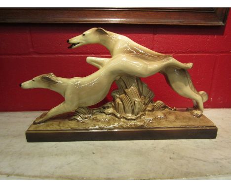 A French ceramic figure of racing greyhounds, stamped Le Maneau, 53cm long 