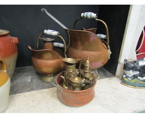 A selection of copper and brass wares with ceramic handled coal buckets, chestnut roaster, jug and pan 