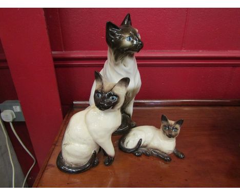 Three ceramic cats; Beswick, Royal Dux and Royal Doulton. Tallest 35cm 