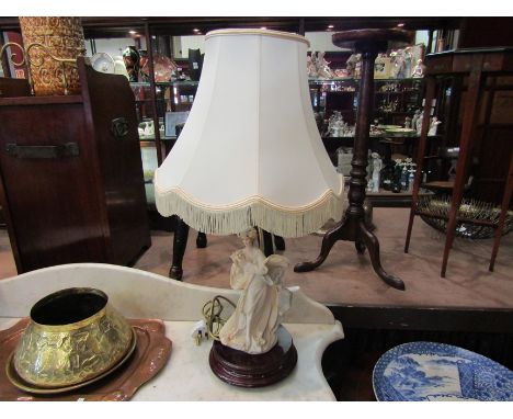 A table lamp in the form of a female figure with white shade 