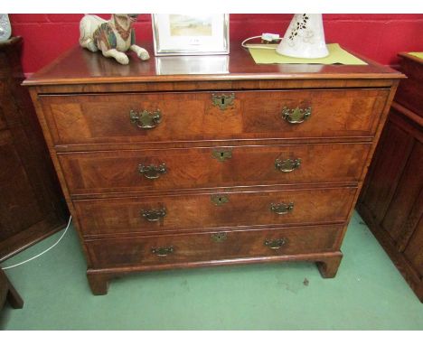 A Circa 1800 crossbanded and figured walnut chest of four long drawers having brass swan handles over bracket feet. 105cm x 1