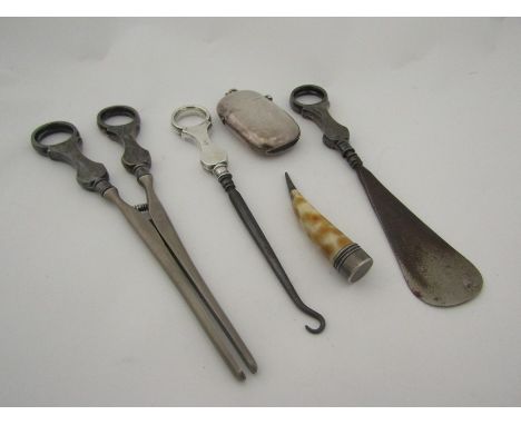 A glove stretcher, button hook and shoe horn all with silver handles and a stained carved bone tooth shaped curio with Giraff