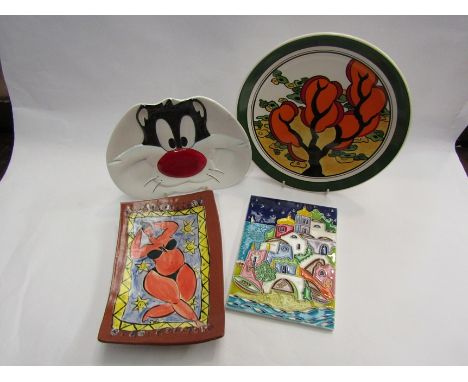 An Eloise Stern ceramic shallow dish decored with a lady sunbathing together with a TM &amp; Co. 1994 Sylvester The Cat dish,