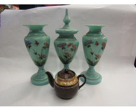 Three ceramic vases depicting flowers, one with lid and teapot 