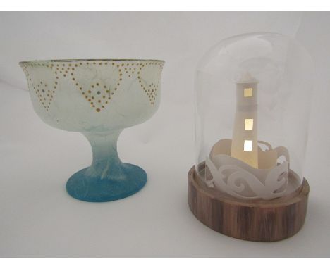 A straw silk glass goblet shaped vase together with a light-up lighthouse in dome 