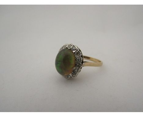 A lady's 9ct gold and opal cabochon ring 