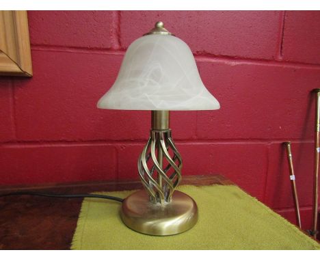 A table lamp with twisted brass effect base and opaque glass shade 