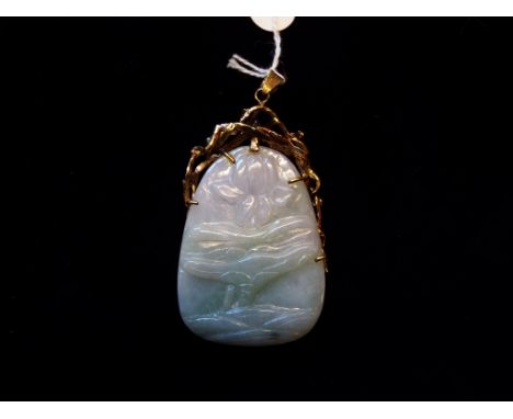 A jade pendant, carved a bird, in a gold mount with diamonds