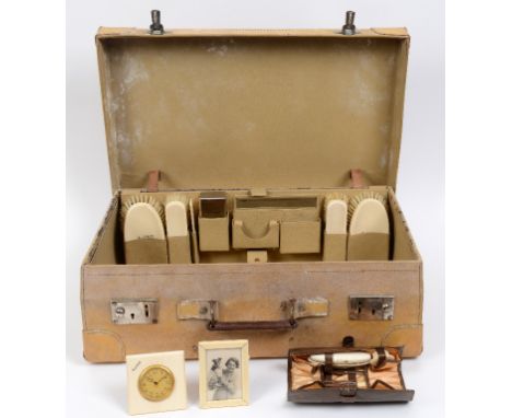 An Art Deco travelling vanity set, with ivory fittings, in a fitted vellum case, with outer travelling cover  See illustratio