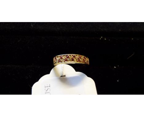 A 9ct yellow gold, ruby and diamond half hoop ring
