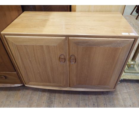 An Ercol elm two door cupboard, 91 cm wide, and an Ercol elm floor standing corner cupboard (2) Condition report Report by GH