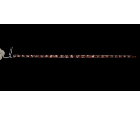 A French ruby and diamond bracelet, of slightly tapering form (with seven spinels), in a Vaughan, London box