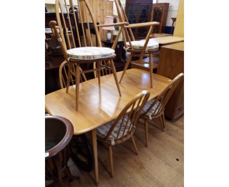 A set of six Ercol elm and beech hoop back dining chairs, and matching dining table (7) Condition report Report by GH

Some l