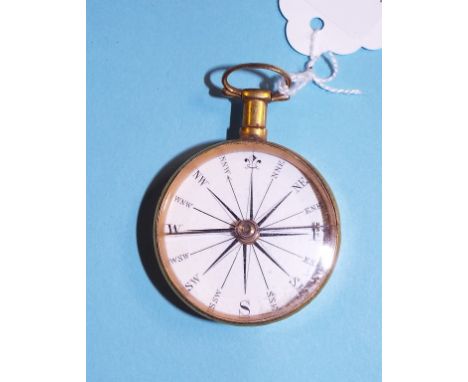 A pocket compass, with a white enamel dial