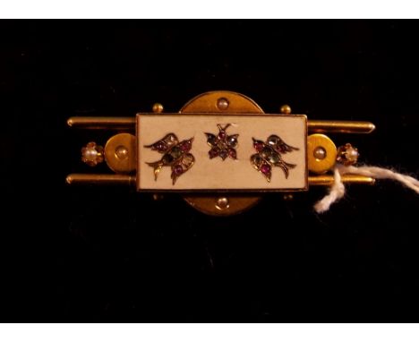 An Aesthetic period yellow coloured metal, enamel and gem set brooch