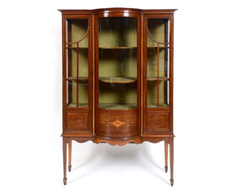 An Edwardian inlaid mahogany display cabinet, with a central bow front section, on tapering square legs, 115 cm wide  See ill