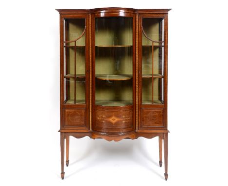 An Edwardian inlaid mahogany display cabinet, with a central bow front section, on tapering square legs, 115 cm wide  See ill