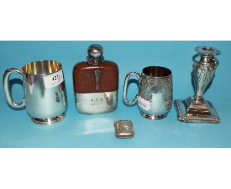 A silver mug, initialled, Birmingham 1937, 9.5 cm high, a silver vesta case, approx. 7.8 ozt, a silver candlestick, a hip fla