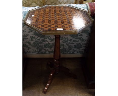 A tripod table, the octagonal top with geometric parquetry inlaid decoration and a brass gallery, 49 cm wide