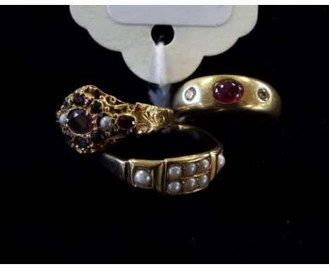 An 18ct gold, ruby and diamond gypsy ring, an 18ct gold and seed pearl ring, and another (3) Condition report Report by NG

1