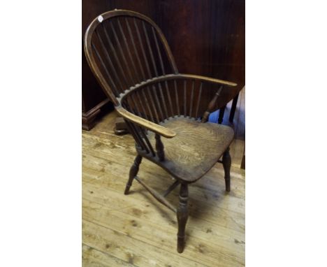 A 19th century beech and elm comb back kitchen armchair