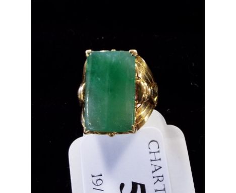 A yellow coloured metal and jade ring